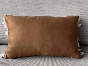 camel brown velvet texture with white tussles and white textured background cushion